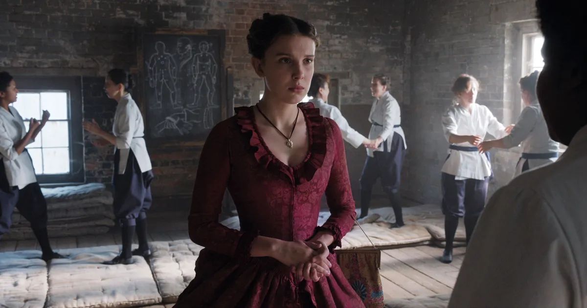 Enola Holmes in a red dress, taking fighting lessons.