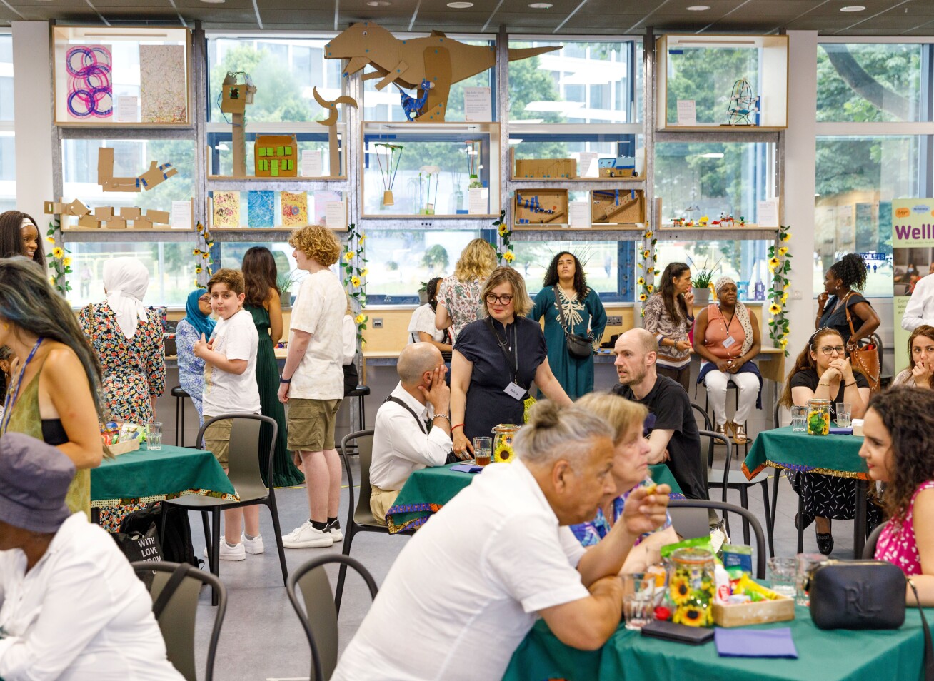 Many women are in a room, busy with various activities