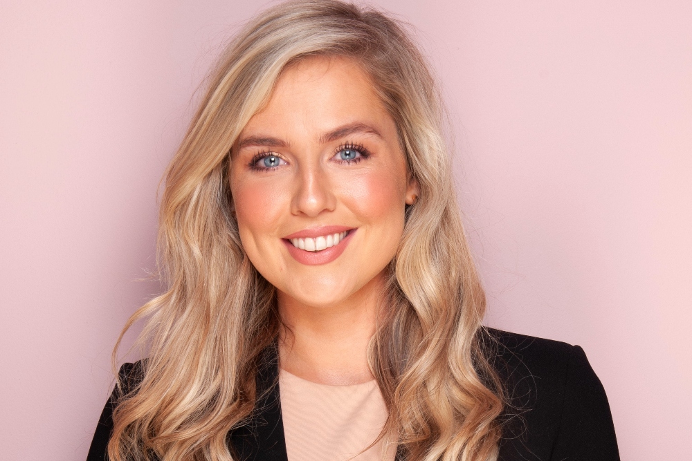 Blonde-haired woman in business suit.