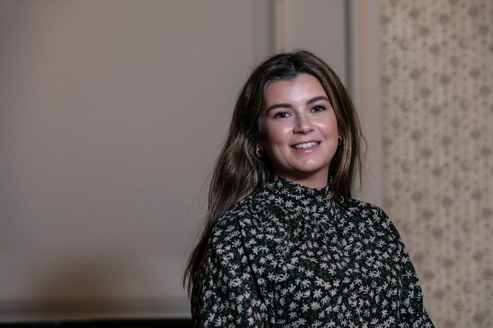 woman in patterned blouse.
