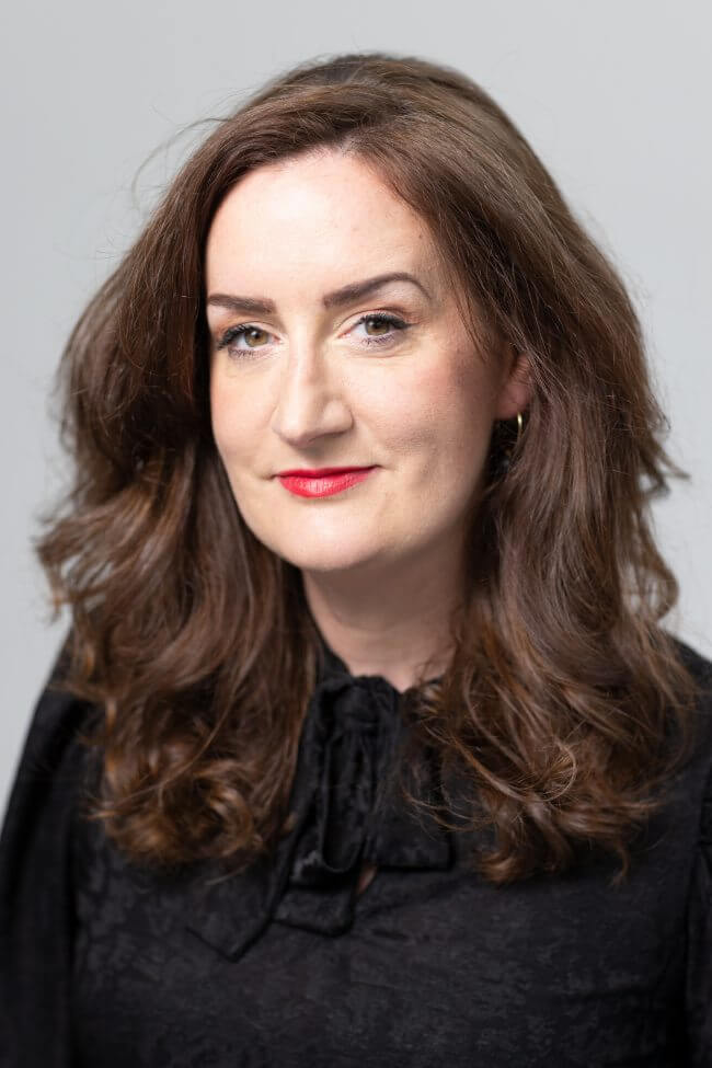 Dark-haired woman in black dress.